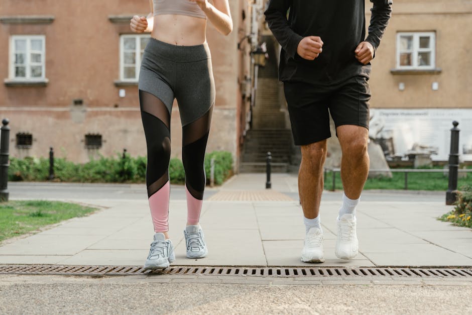 Two adults jogging outdoors, promoting health and fitness in an urban setting.