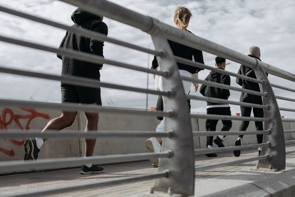 A group jogging outdoors on an urban bridge, promoting fitness and wellness.